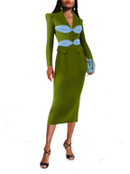 Green dress with blue accents worn by a model on a white background