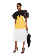 Woman wearing a black, yellow, and white dress with puffed sleeves on a white background