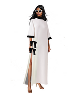 Woman wearing a white dress with black accents on a white background