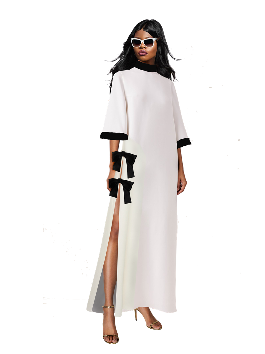 Woman wearing a white dress with black accents on a white background