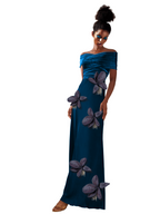 Woman wearing a blue evening gown with floral embellishments on a white background