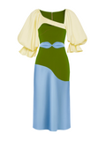 Green and blue dress with yellow sleeves on a white background