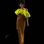 Woman wearing a mustard yellow off-shoulder dress with ruffled top on a black background