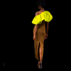 Woman wearing a mustard yellow dress with bright yellow sleeves on a black background