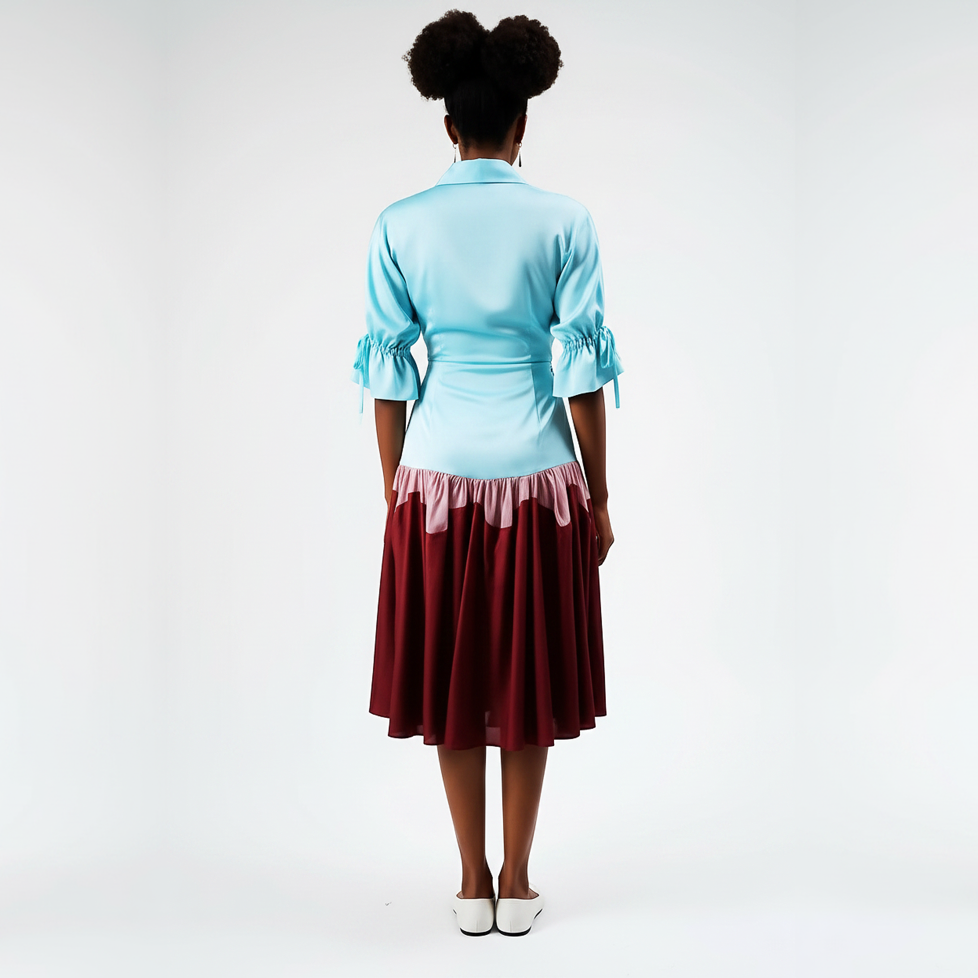 Person wearing a light blue top and maroon skirt on a white background