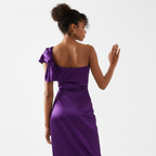 Woman wearing a purple one-shoulder dress on a white background