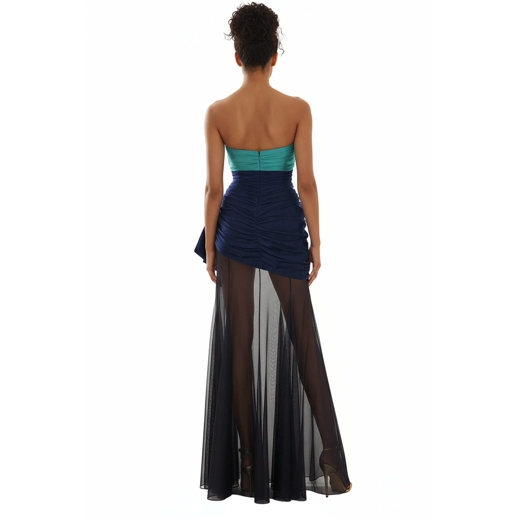 Woman wearing a strapless teal top and navy blue dress with sheer black panels on a white background