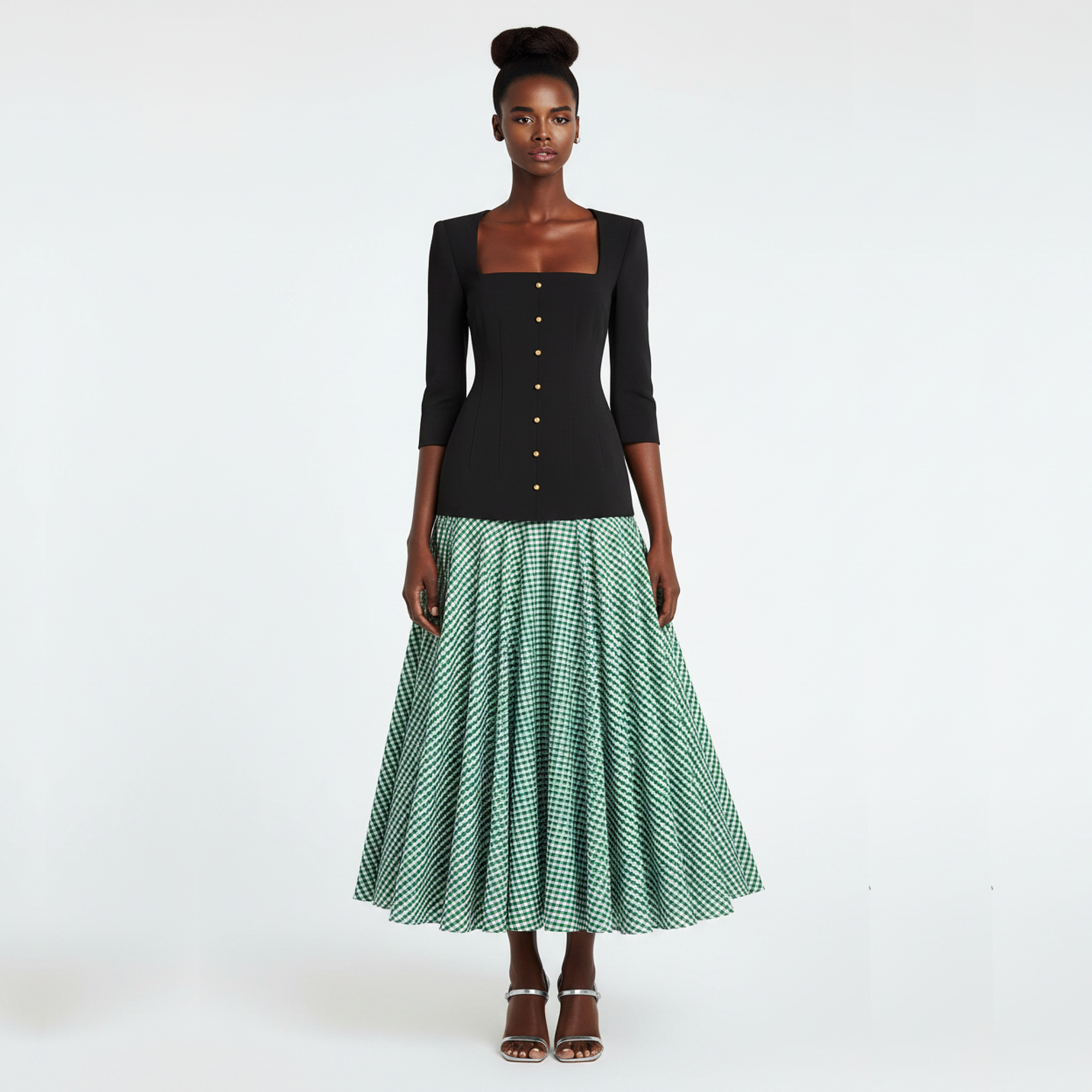 Woman wearing a black top and green checkered skirt on a white background