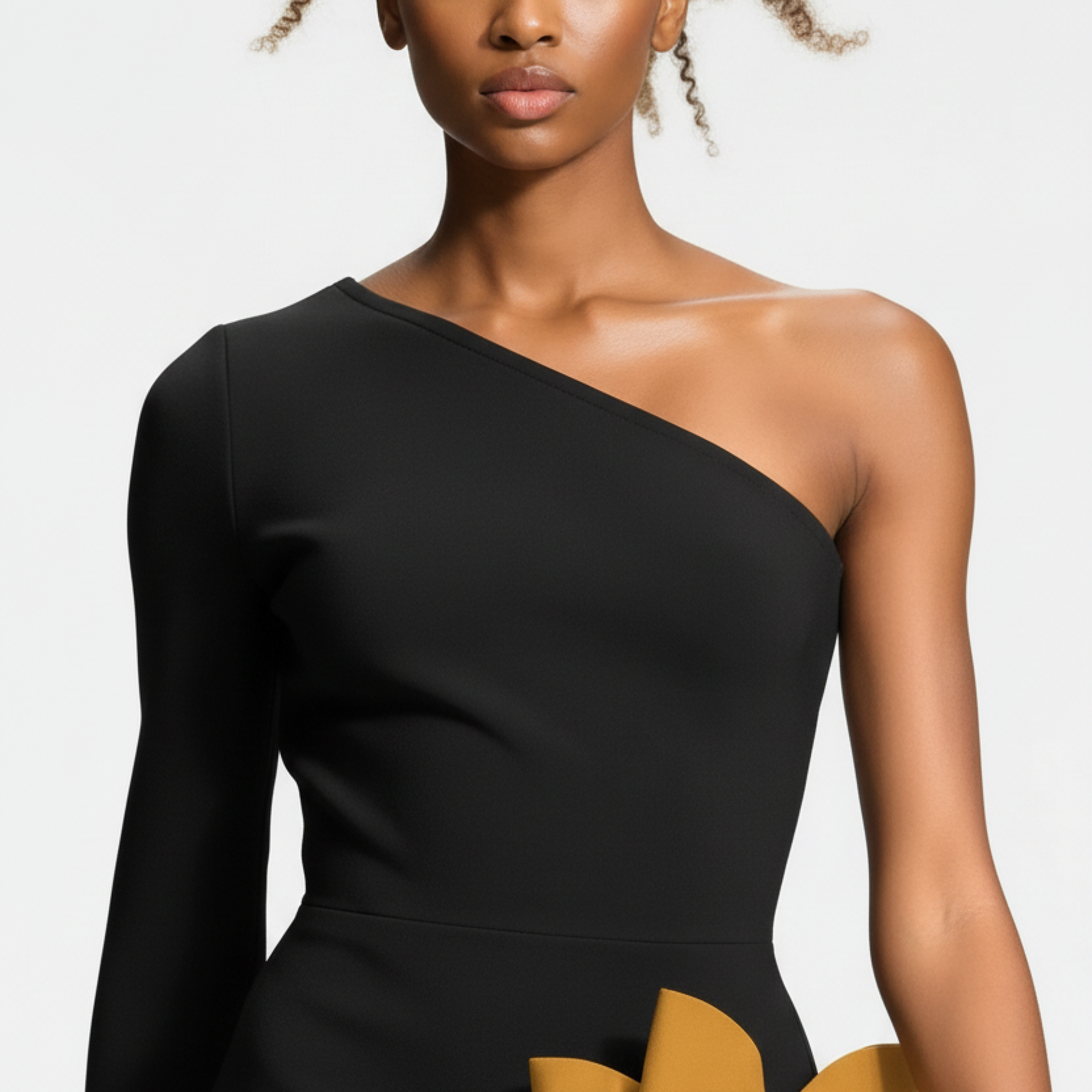 Black one-shoulder dress worn by a model on a white background
