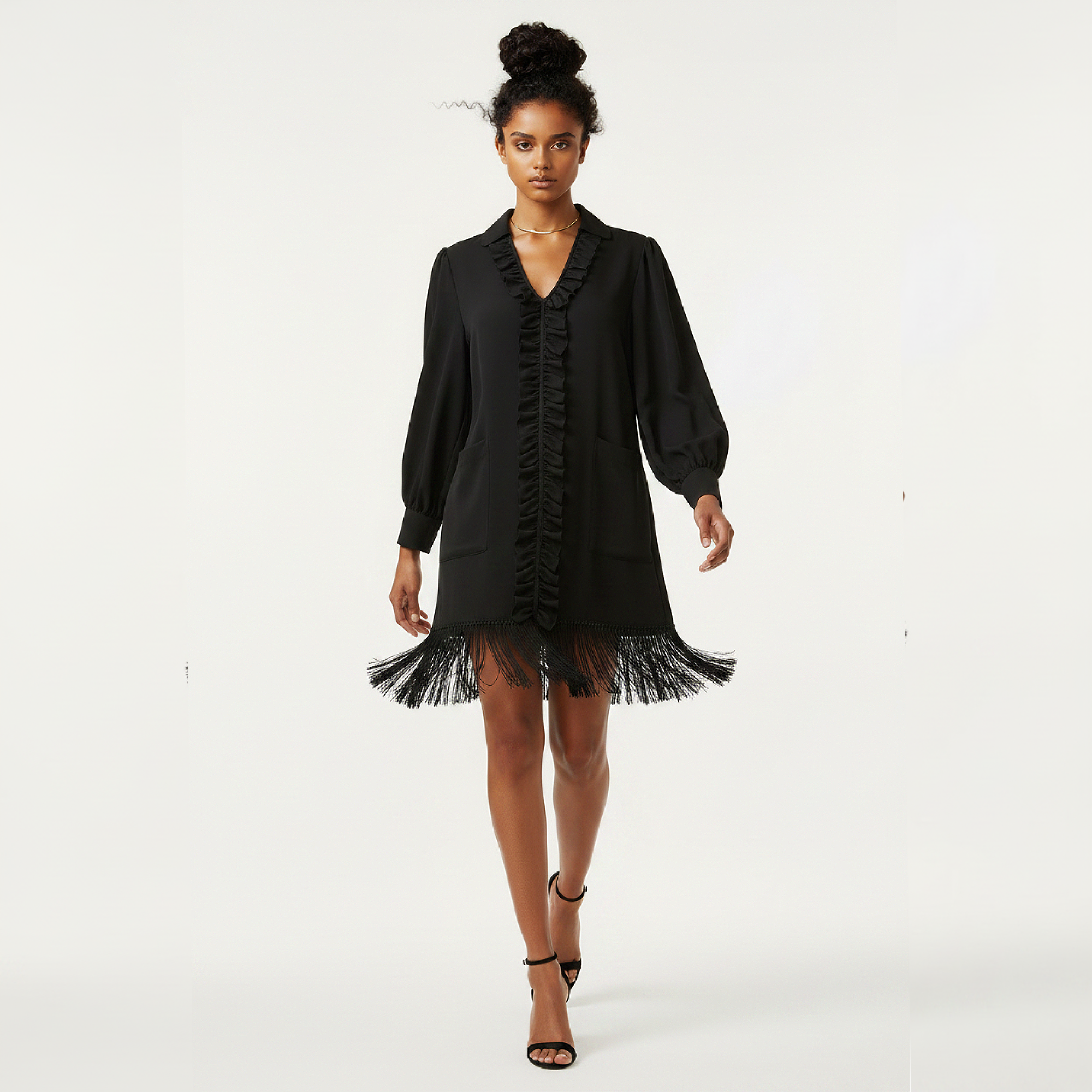 Woman wearing a black dress with ruffled details on a white background