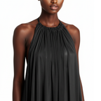 Black halter neck dress worn by a model on a white background