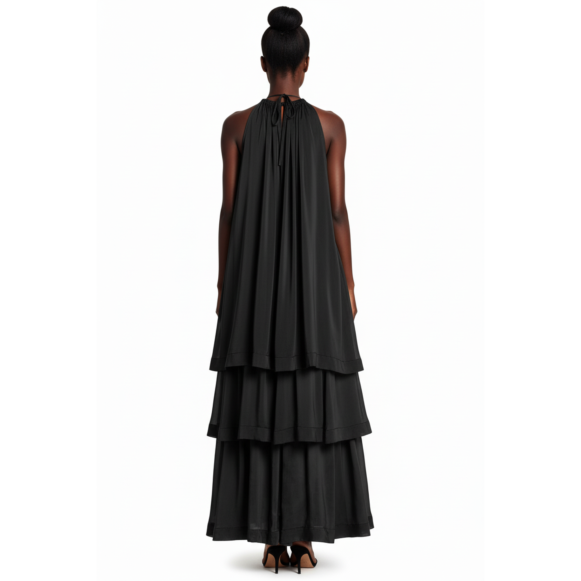 Black tiered dress worn by a model on a white background