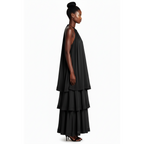 Woman wearing a black layered dress on a white background