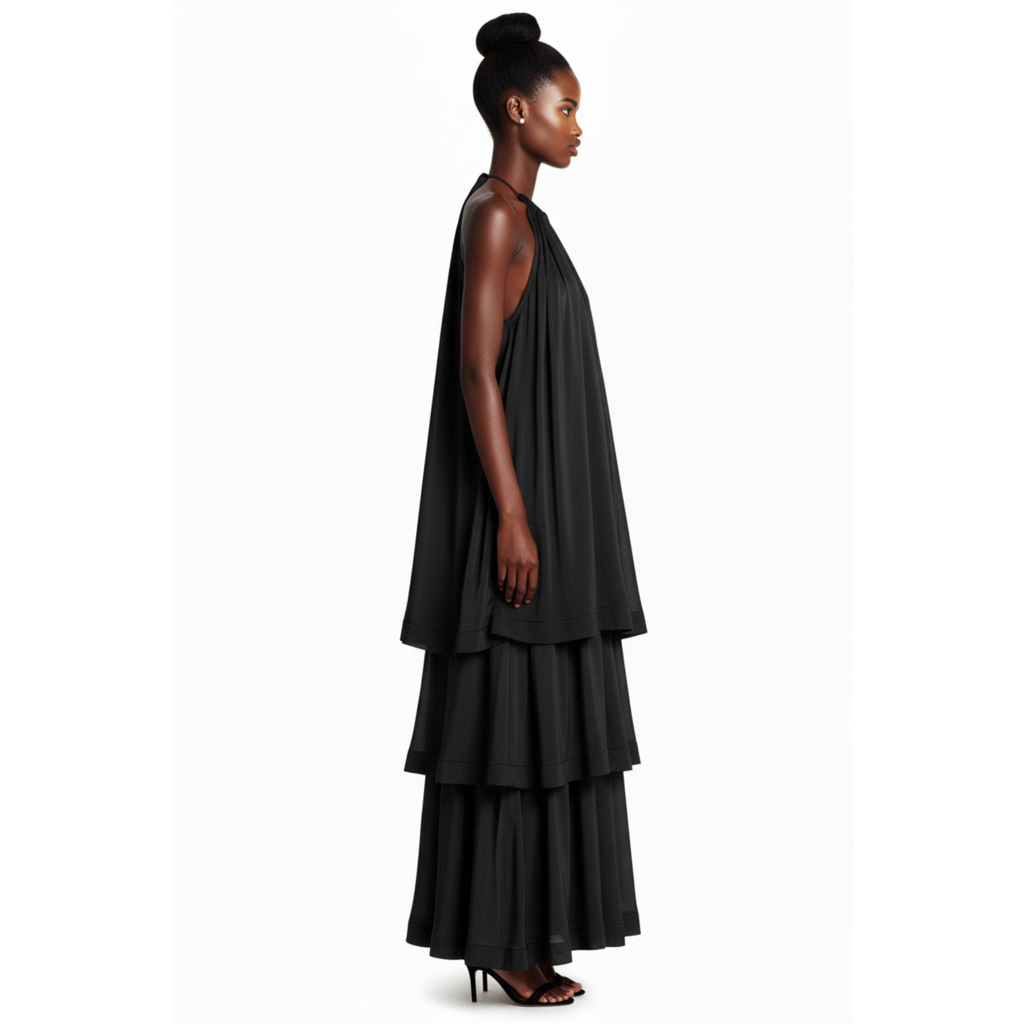 Woman wearing a black layered dress on a white background