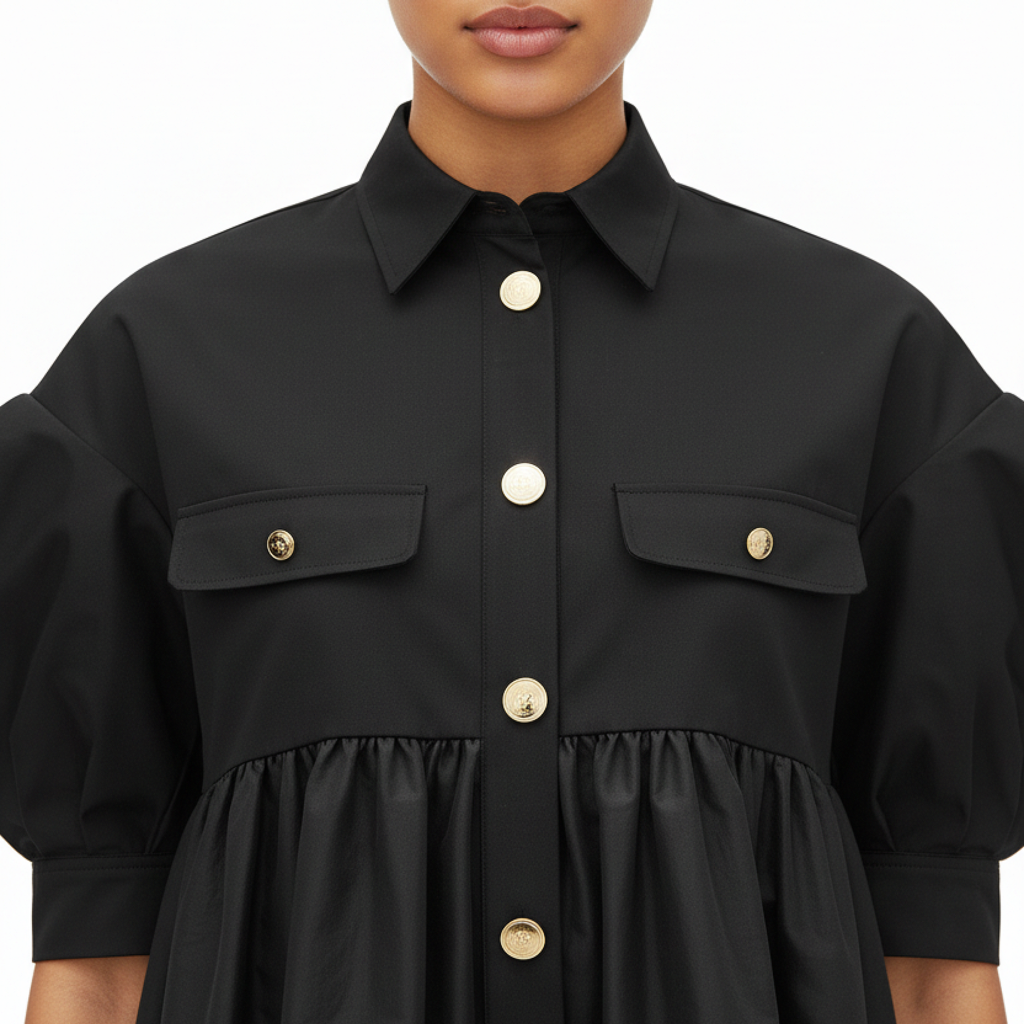 Black dress with gold buttons on a white background