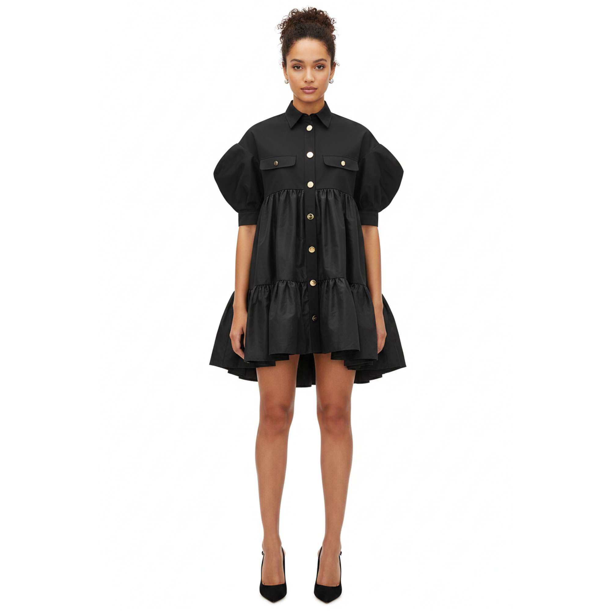 Woman wearing a black dress with puff sleeves on a white background