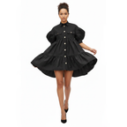 Woman wearing a black dress with white buttons on a white background