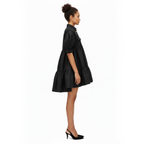 Woman wearing a black dress on a white background