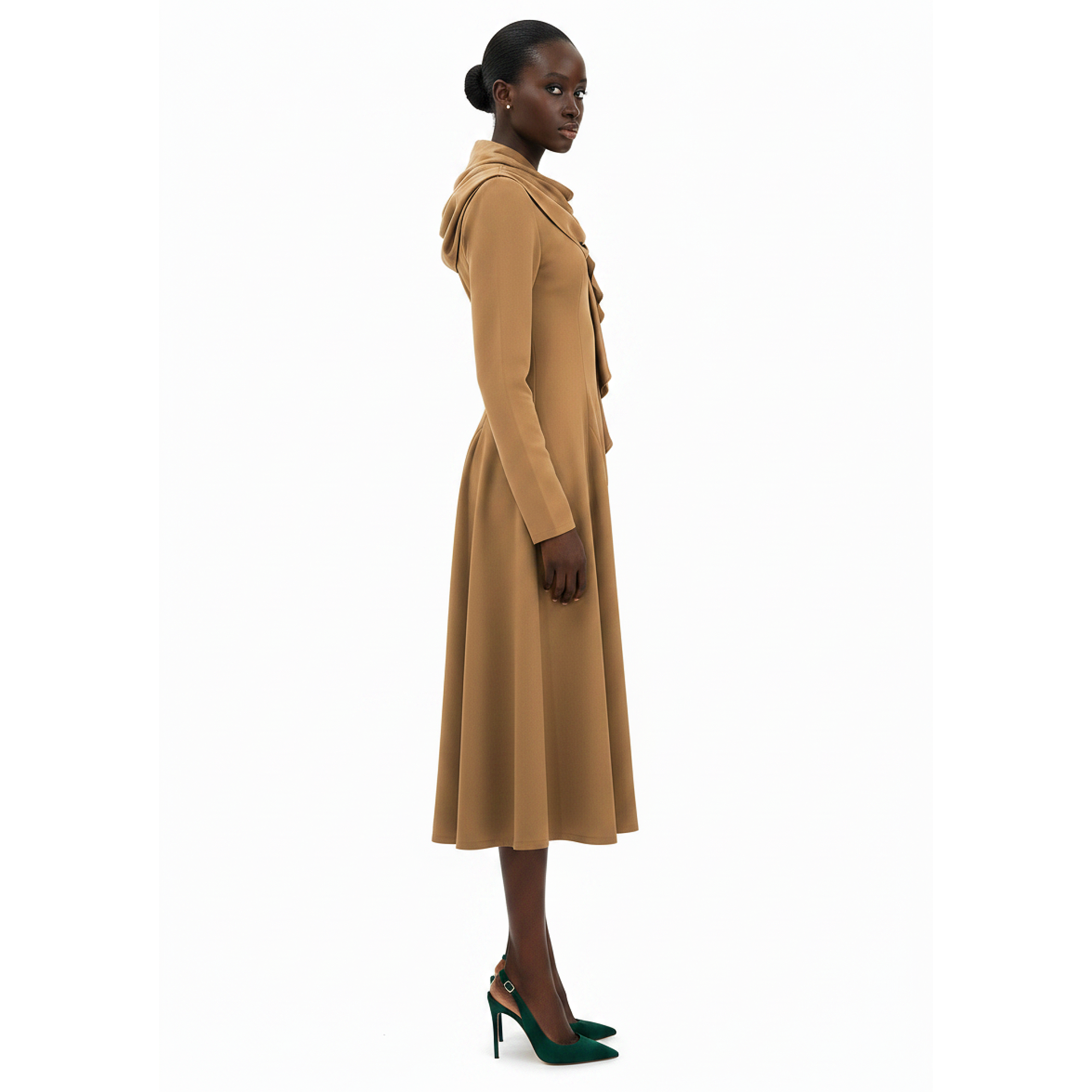 Woman wearing a long beige coat on a white background