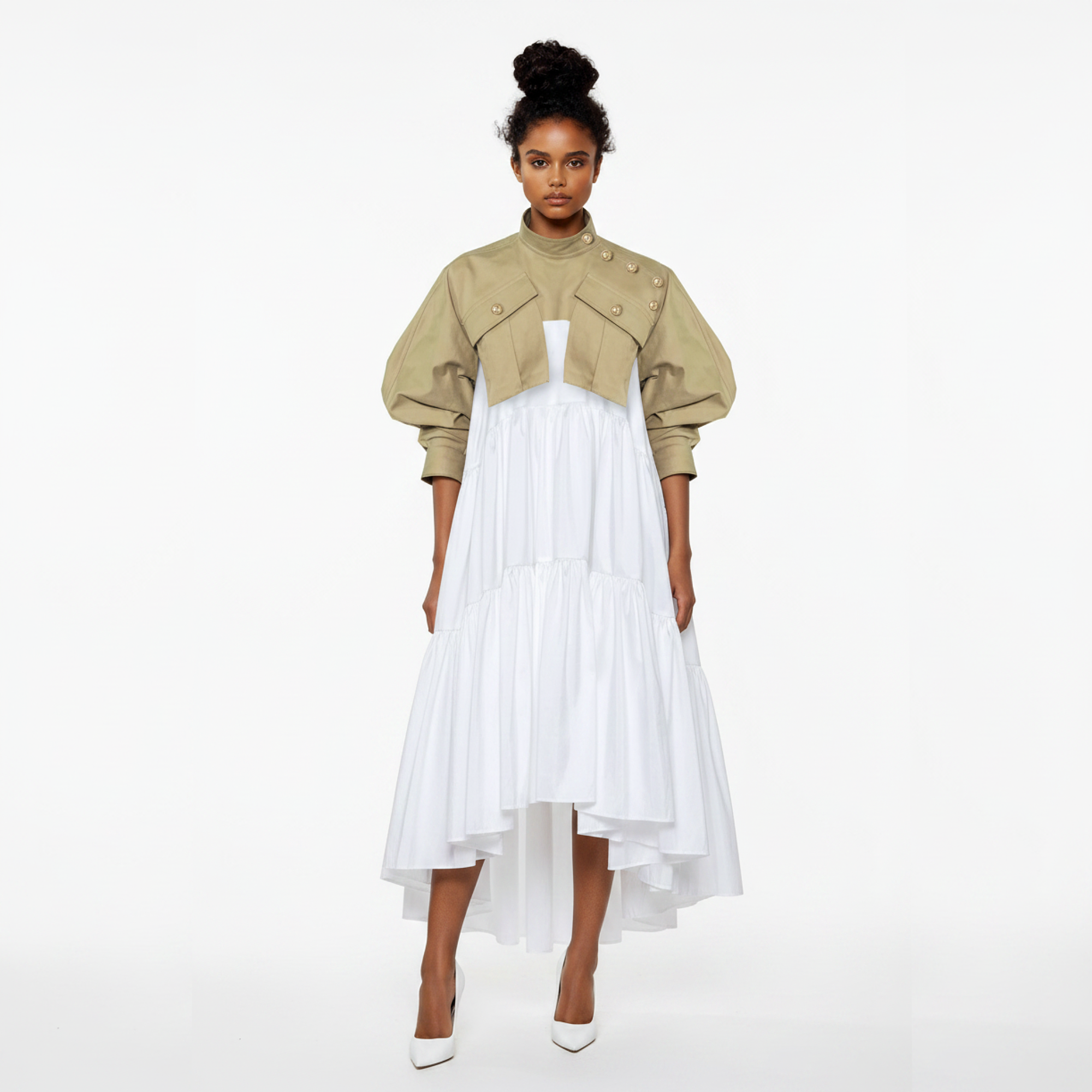 Woman wearing a beige jacket over a white dress on a white background