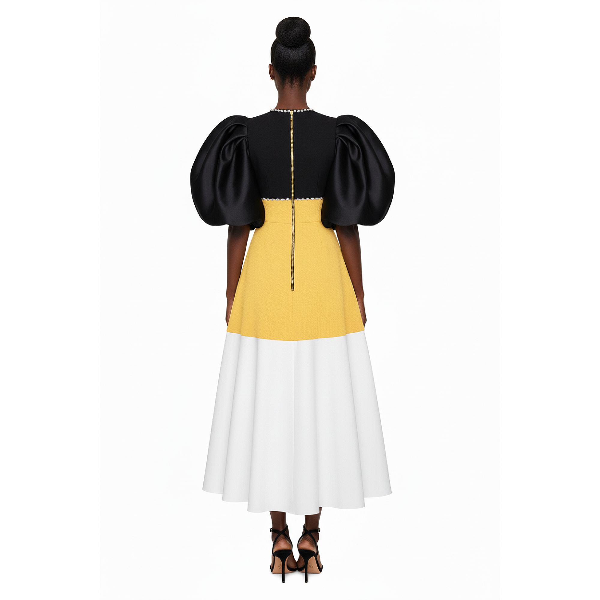 Woman wearing a black, yellow, and white dress on a white background