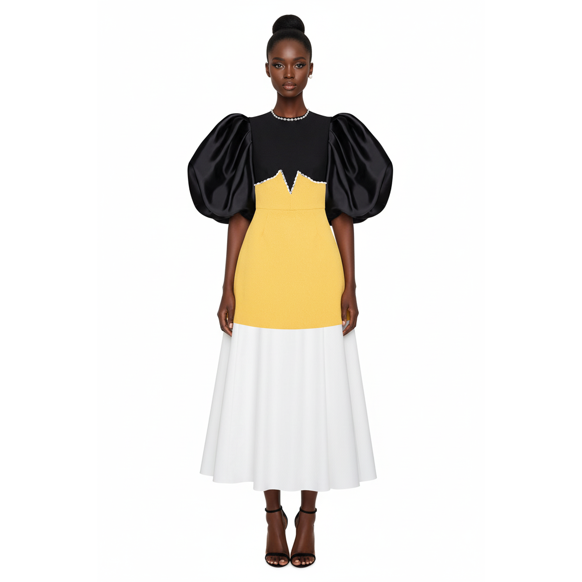 Woman wearing a dress with black, yellow, and white color block design on a white background