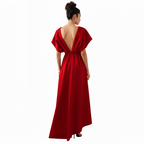Woman wearing a red evening gown with a deep back on a white background