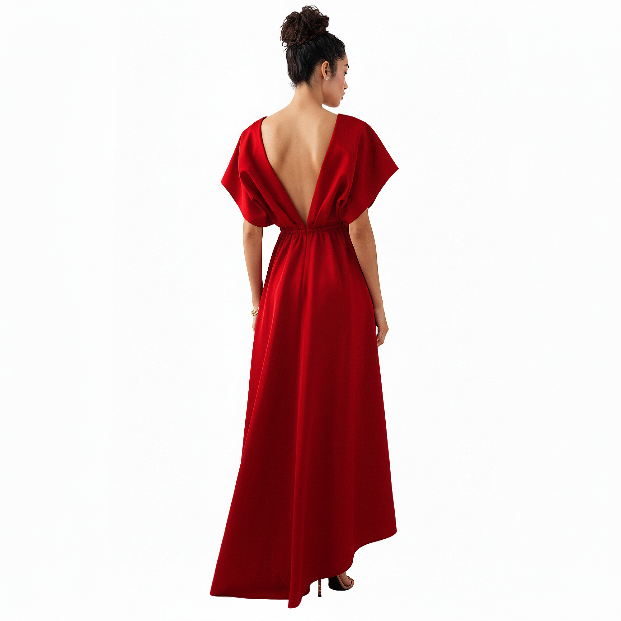 Woman wearing a red evening gown with a deep back on a white background