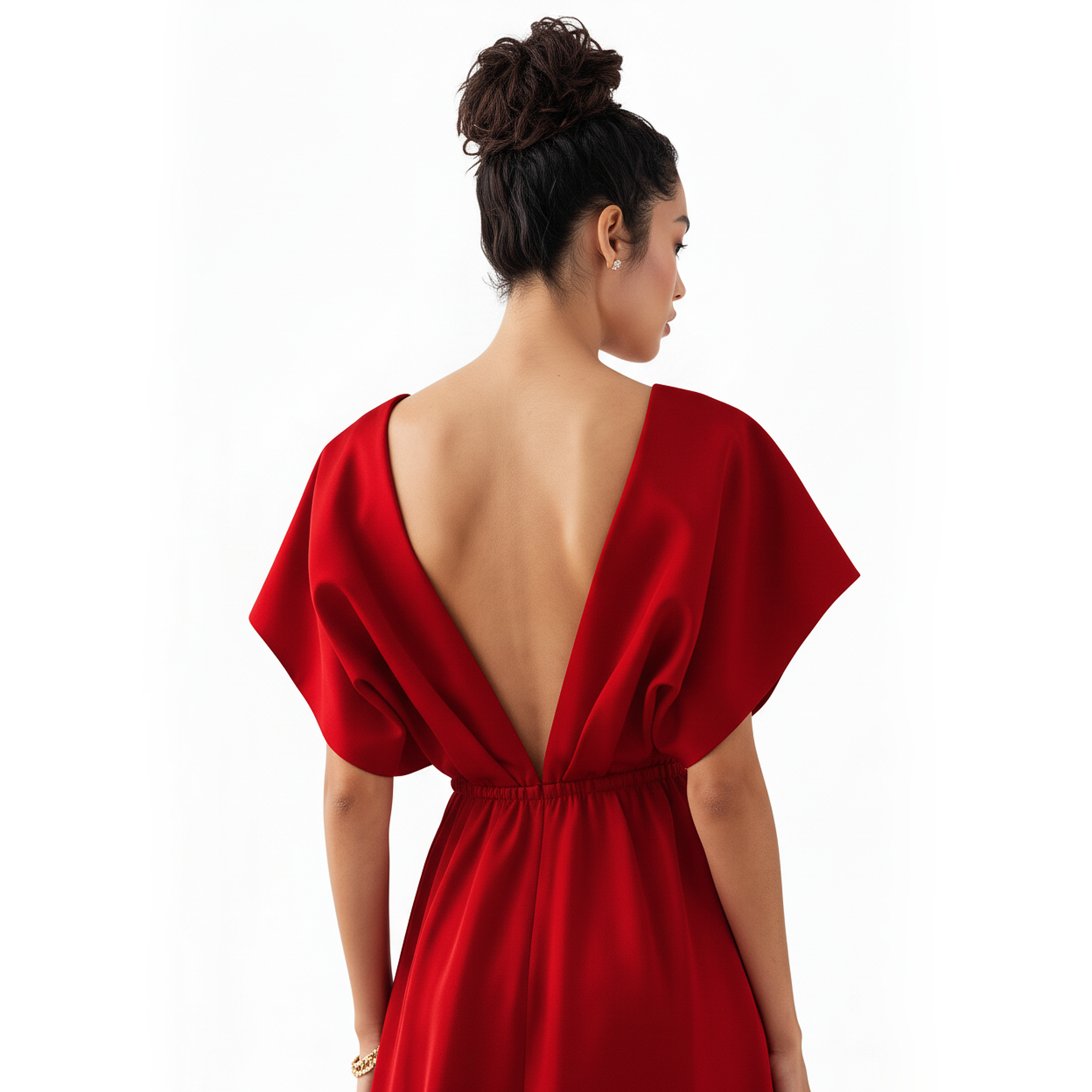 Woman wearing a red dress with an open back on a white background