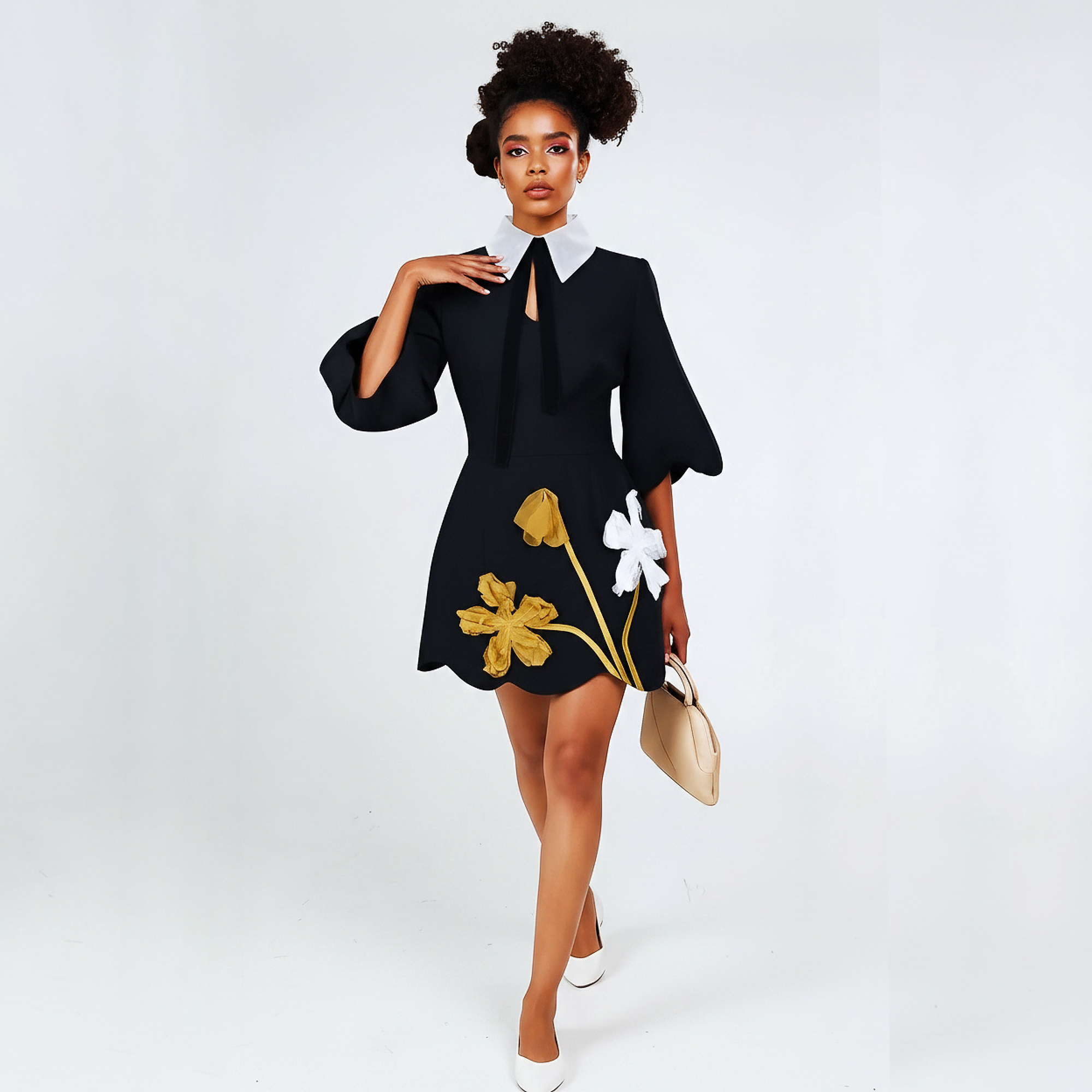 Woman wearing a black dress with floral designs on a white background