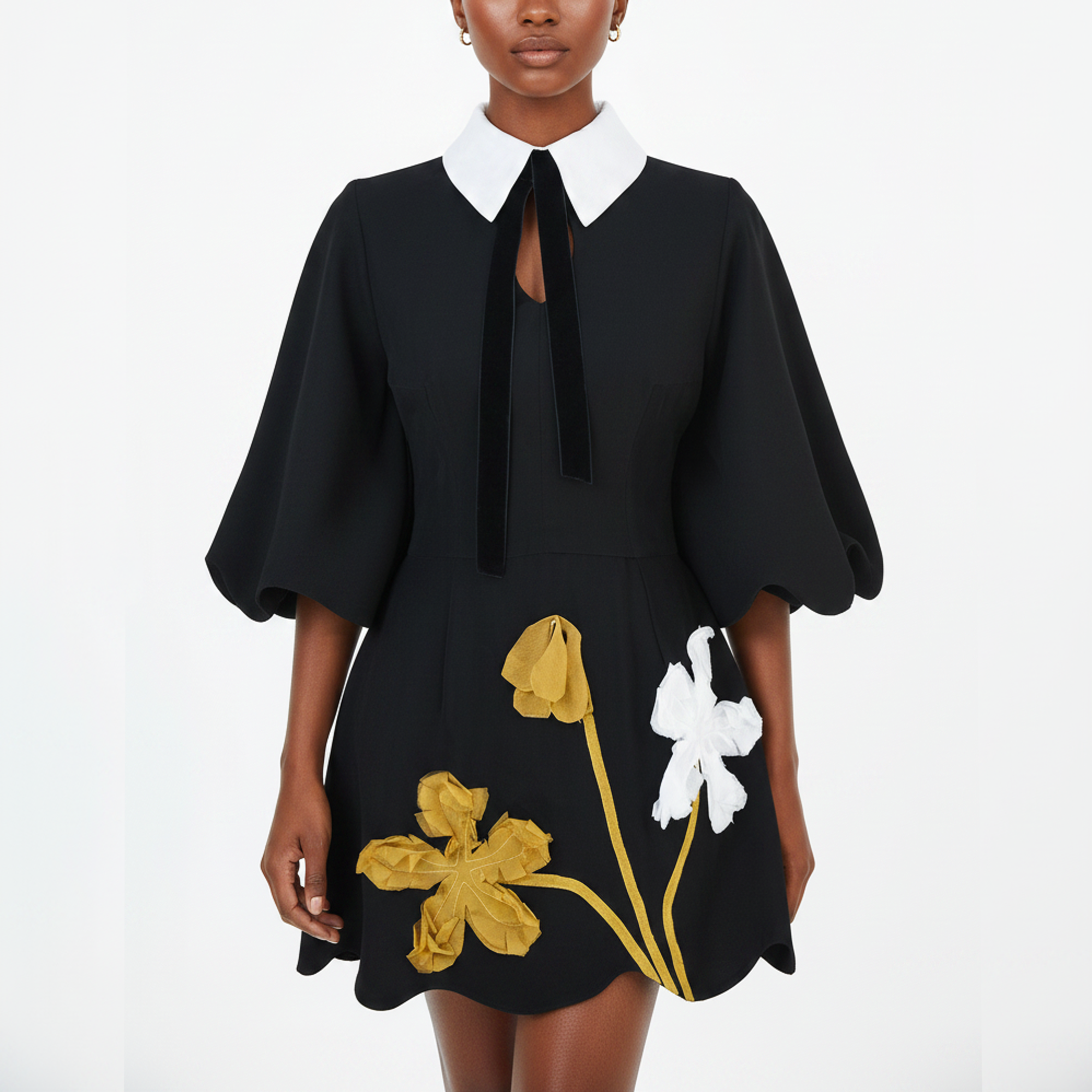 Black dress with floral embroidery on a white background