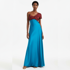 Woman wearing a two-tone dress with a red top and blue skirt on a white background