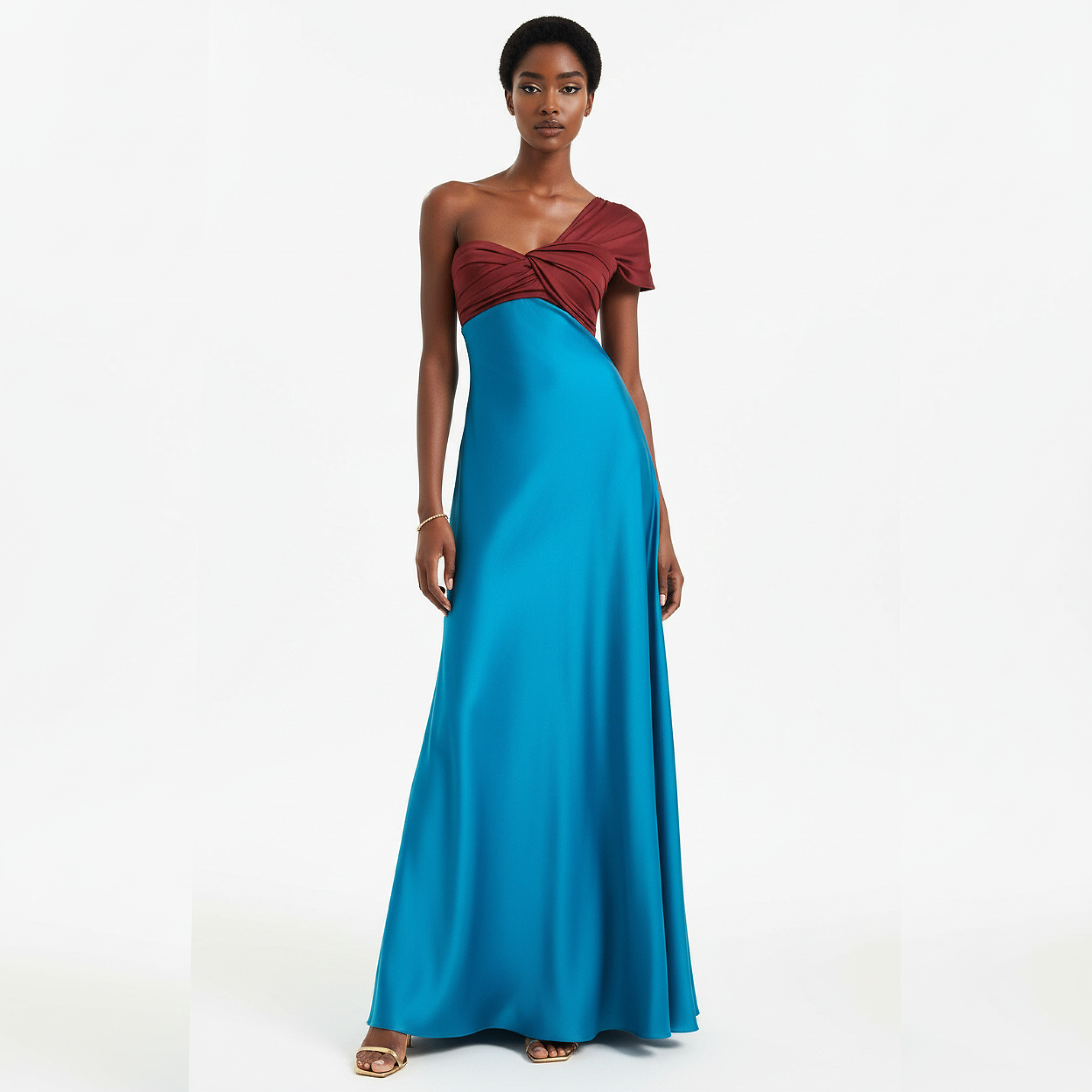 Woman wearing a two-tone dress with a red top and blue skirt on a white background