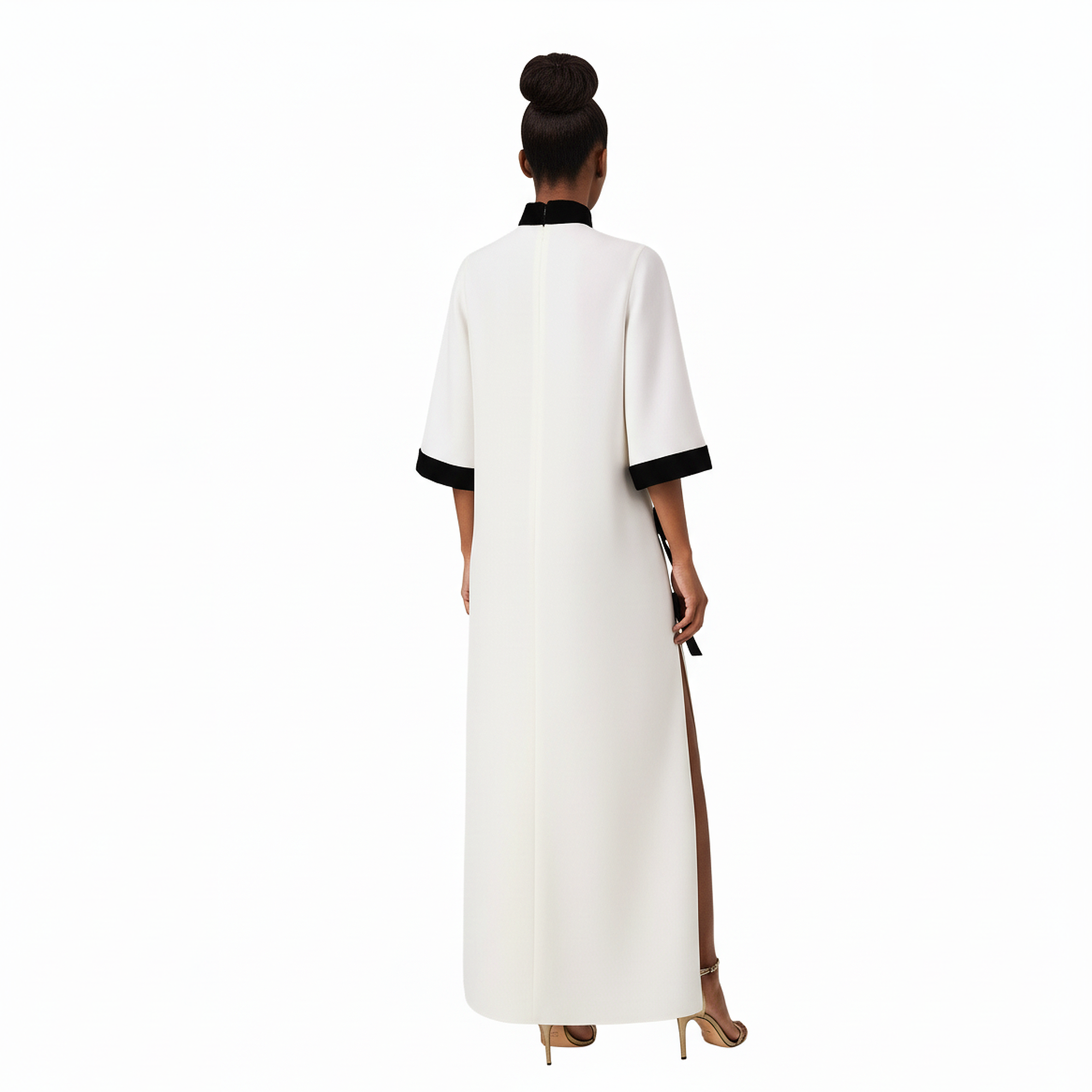 Woman wearing a white dress with black trim on a white background