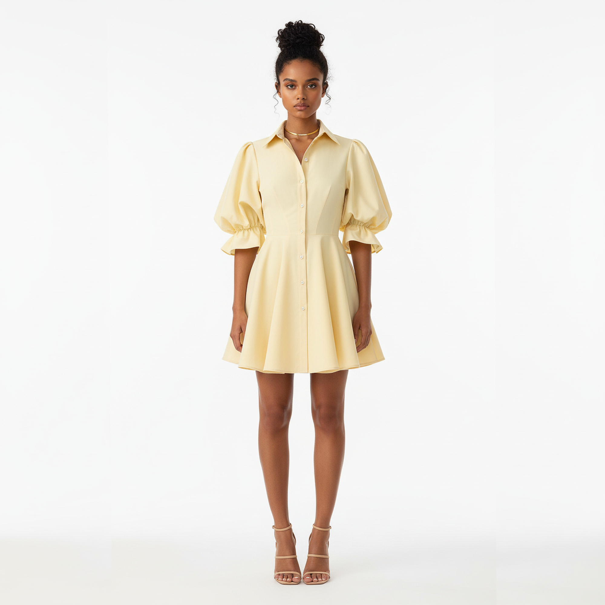 Woman wearing a light yellow dress on a white background