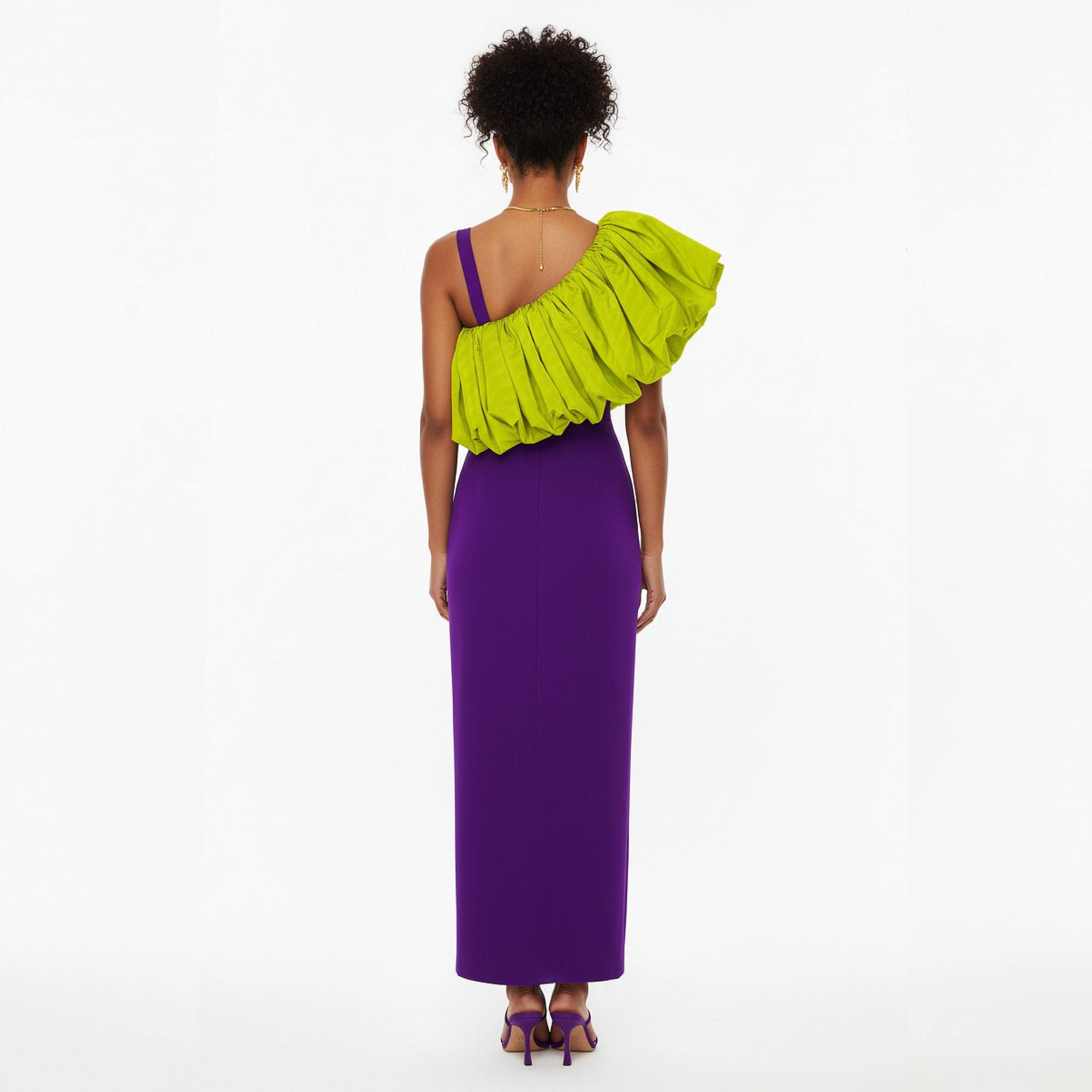 Woman wearing a purple one-shoulder dress with a green ruffled shoulder on a white background