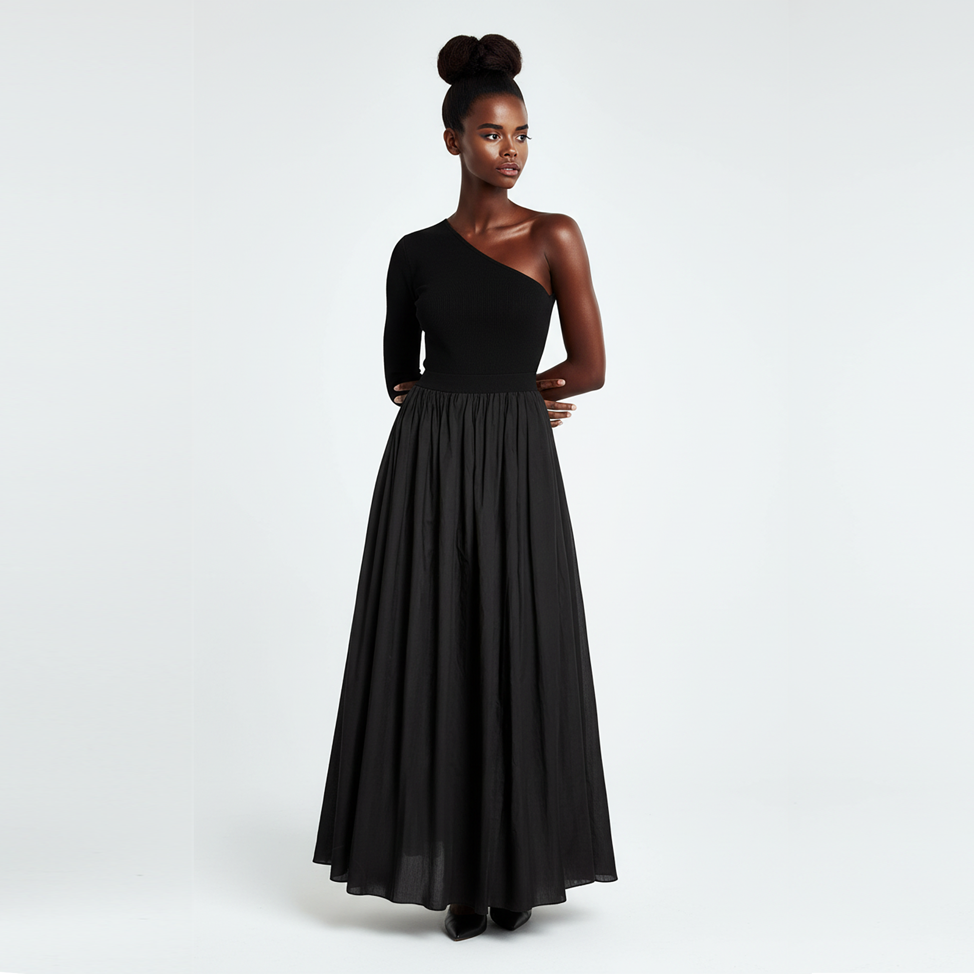 Woman wearing a black one-shoulder dress on a white background