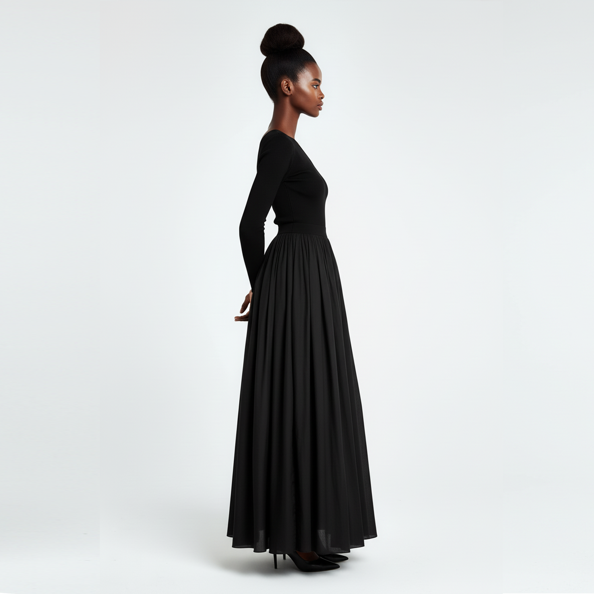 Woman wearing a long black dress on a white background