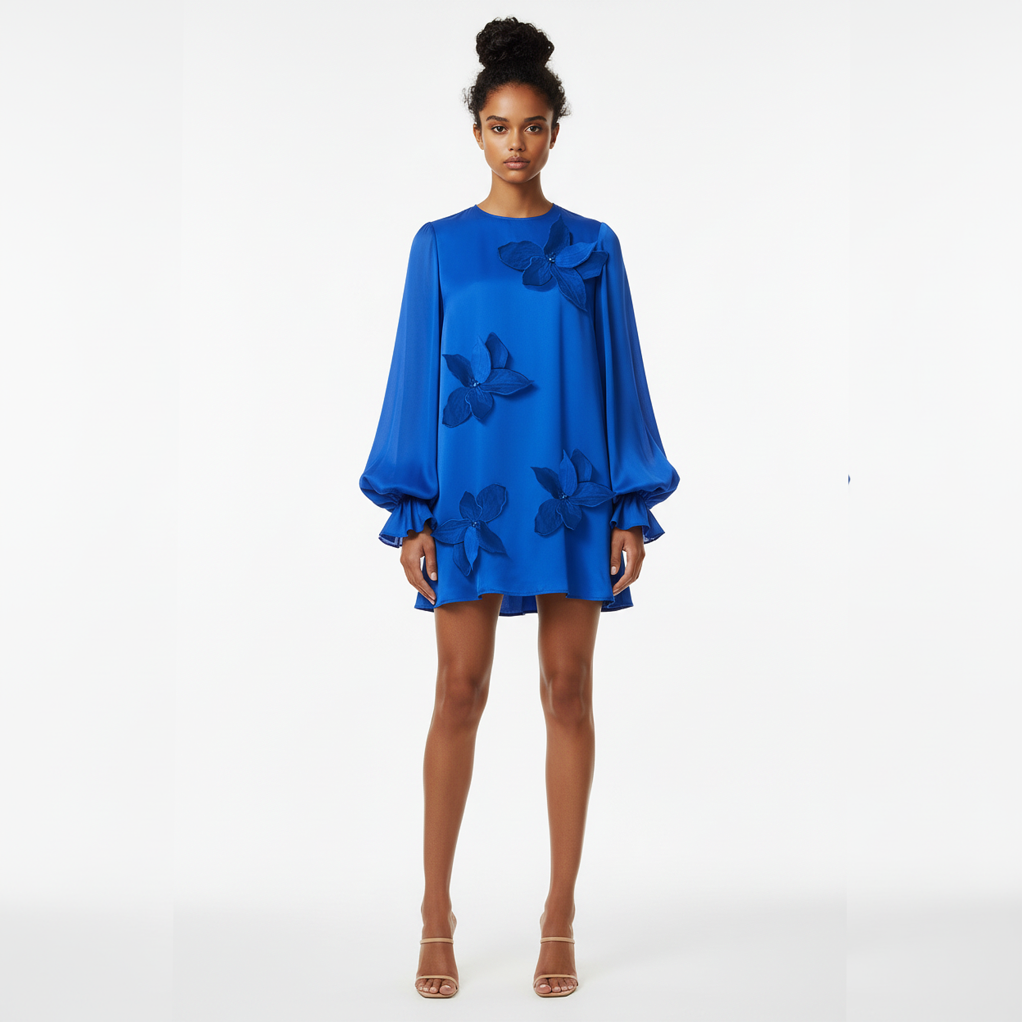 Woman wearing a blue dress with floral details on a white background